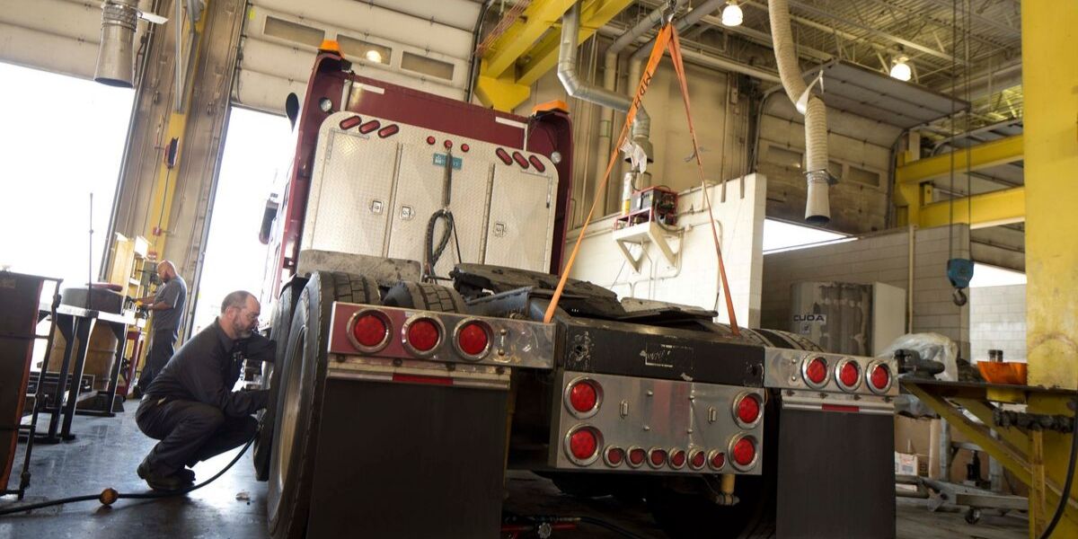 Mechanic working on semi-trailer truck