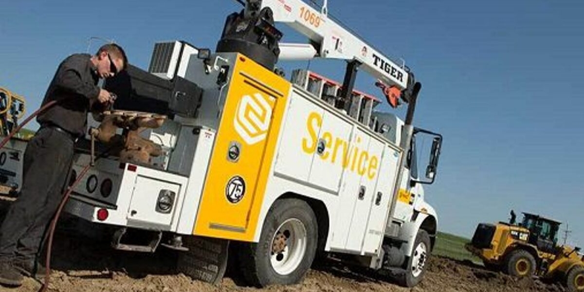 Diesel mechanic working on service truck