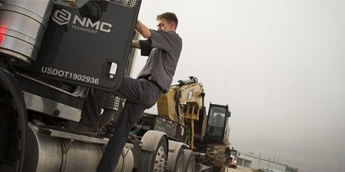 Man stepping into NMC transport vehicle