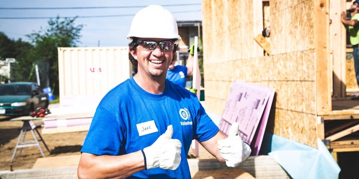 Habitat for humanity volunteer giving two thumbs up