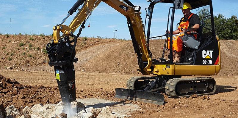 Cat mini excavator with drill attachment