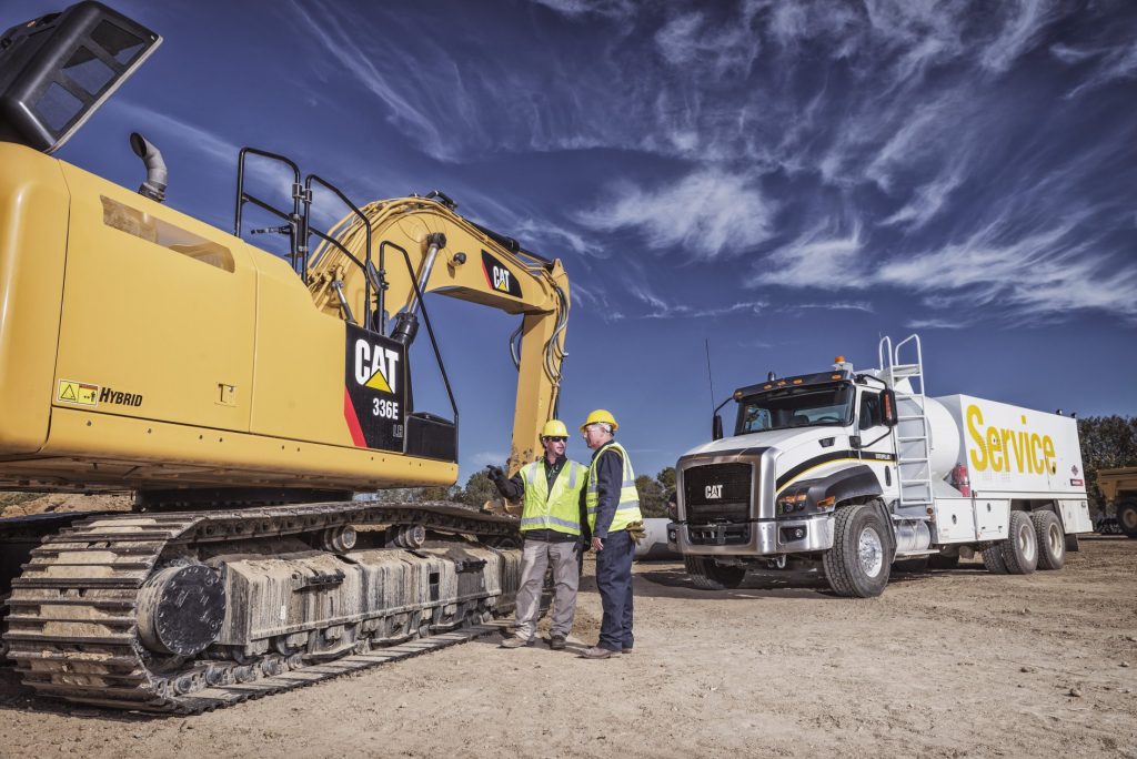 a NMC Cat Service truck behind a heavy construction equipment rental 