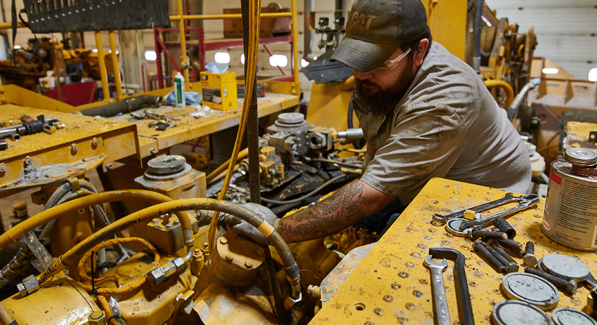 Worker doing maintenance on machine