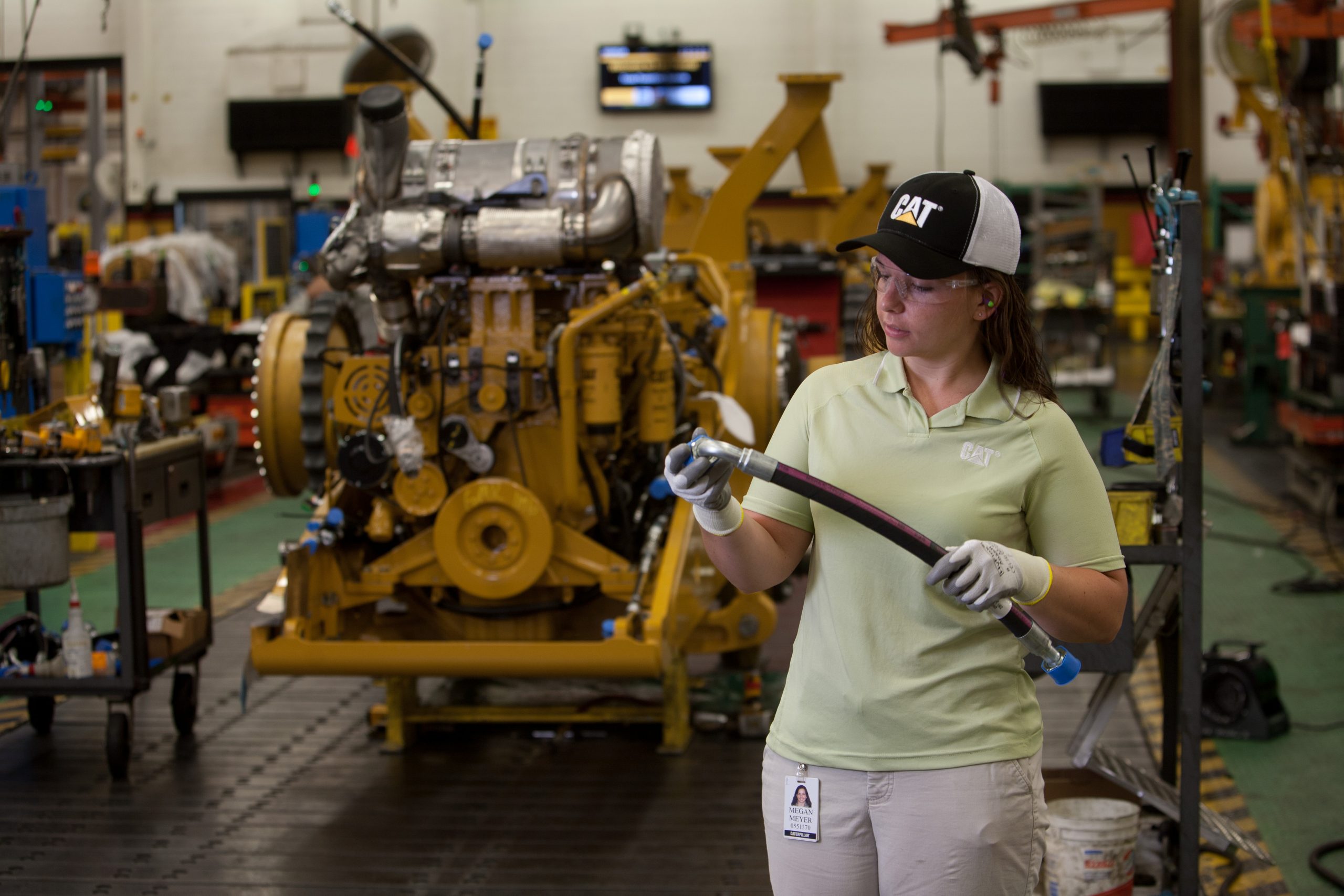 female CAT employee working with pipes